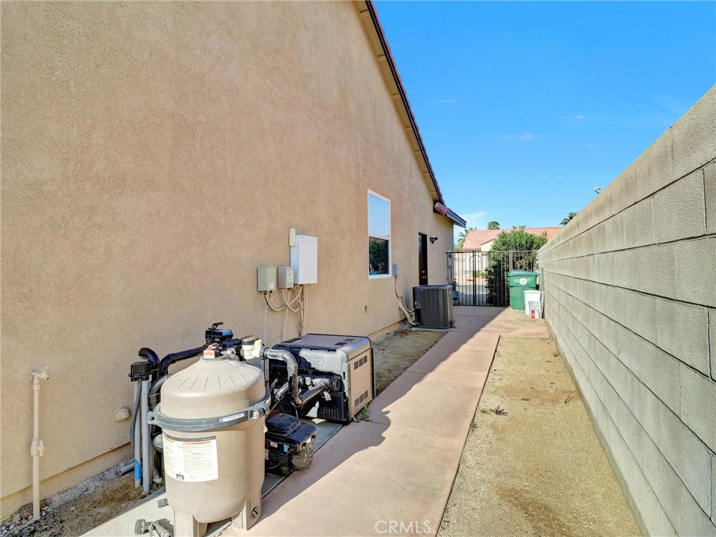 47718 Phoenix Street Indio, CA 92201 - Photo 52 of 54 a view of a patio with table and chairs next to a yard