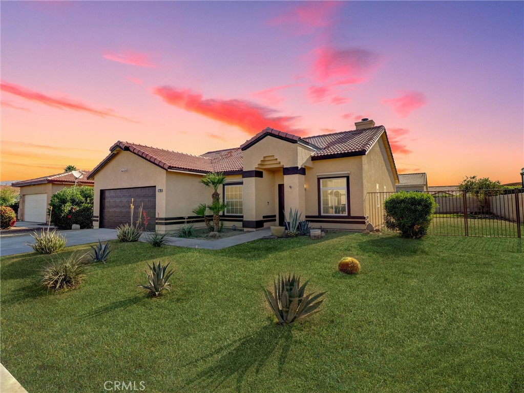 47718 Phoenix Street Indio, CA 92201 - Photo 53 of 54 a front view of a house with a yard and trees