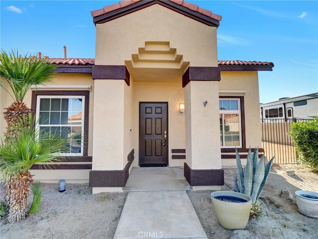 47718 Phoenix Street Indio, CA 92201 - Photo 10 of 54 a front view of a house with outdoor seating