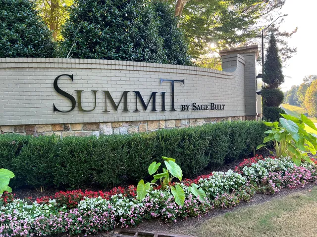 a sign that is in front of flowers