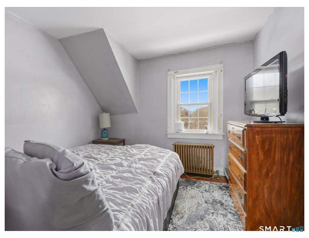 195 Bokum Road Old Saybrook, CT 06475 - Photo 14 of 30 a bedroom with a bed and flat tv screen