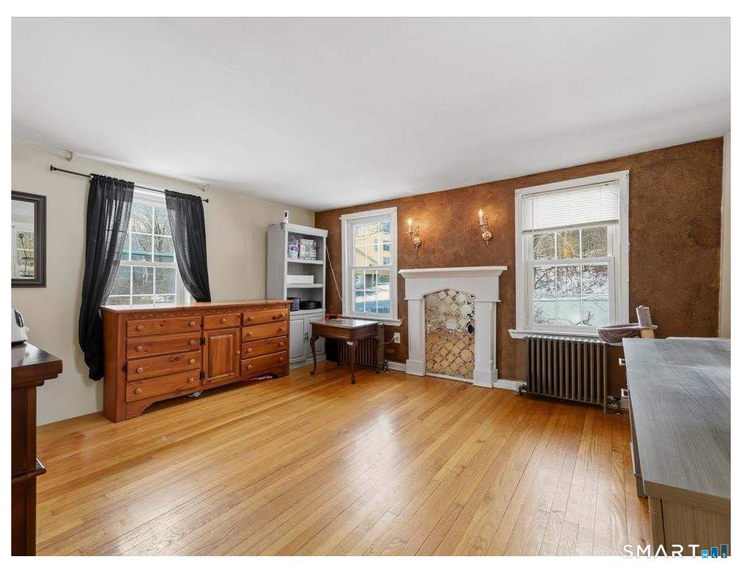 195 Bokum Road Old Saybrook, CT 06475 - Photo 17 of 30 a living room with furniture and a flat screen tv