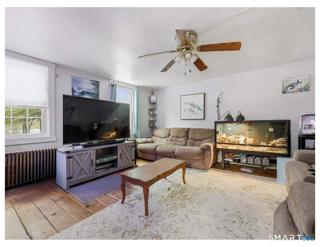 195 Bokum Road Old Saybrook, CT 06475 - Photo 5 of 30 a living room with furniture and a flat screen tv