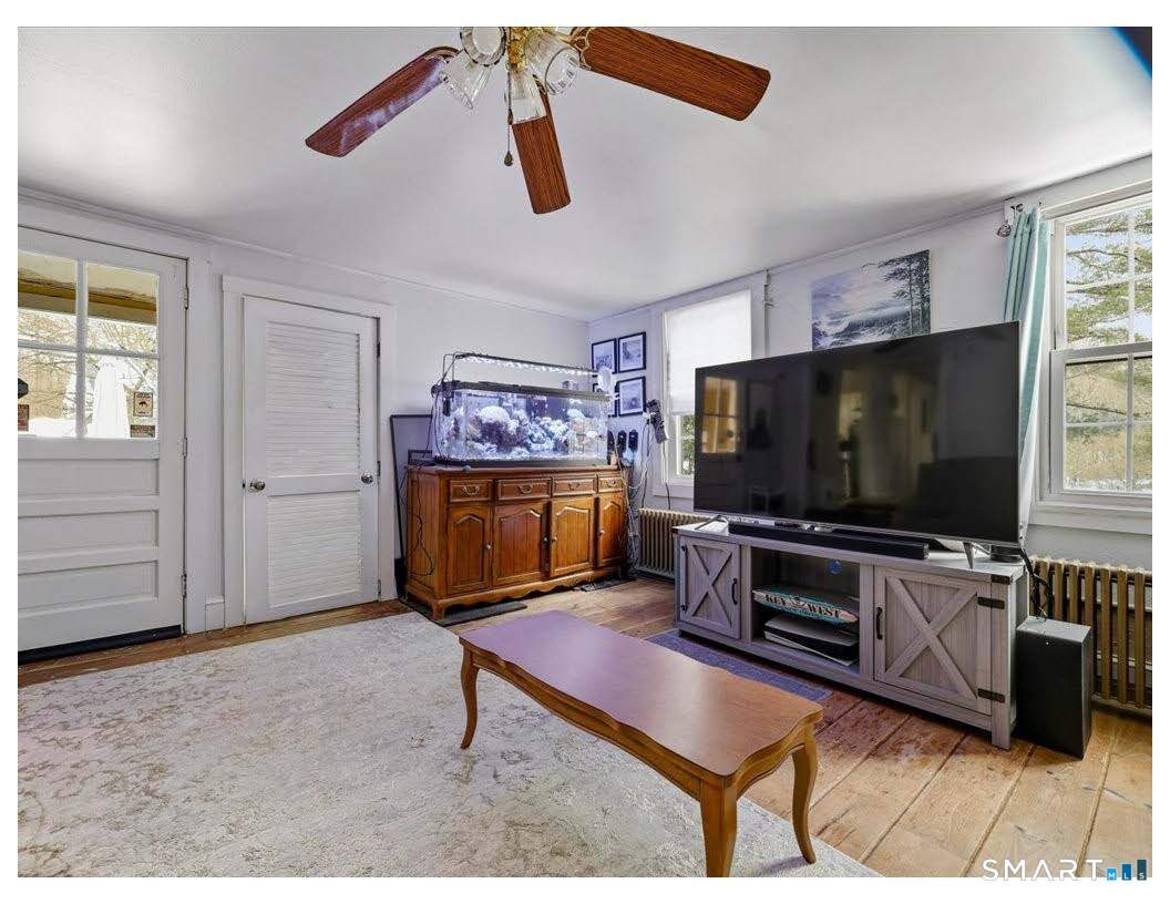 195 Bokum Road Old Saybrook, CT 06475 - Photo 6 of 30 a living room with furniture and a flat screen tv