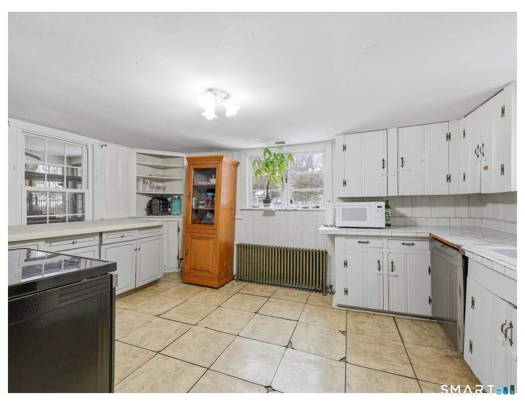 195 Bokum Road Old Saybrook, CT 06475 - Photo 8 of 30 a kitchen with a stove a sink dishwasher and a refrigerator