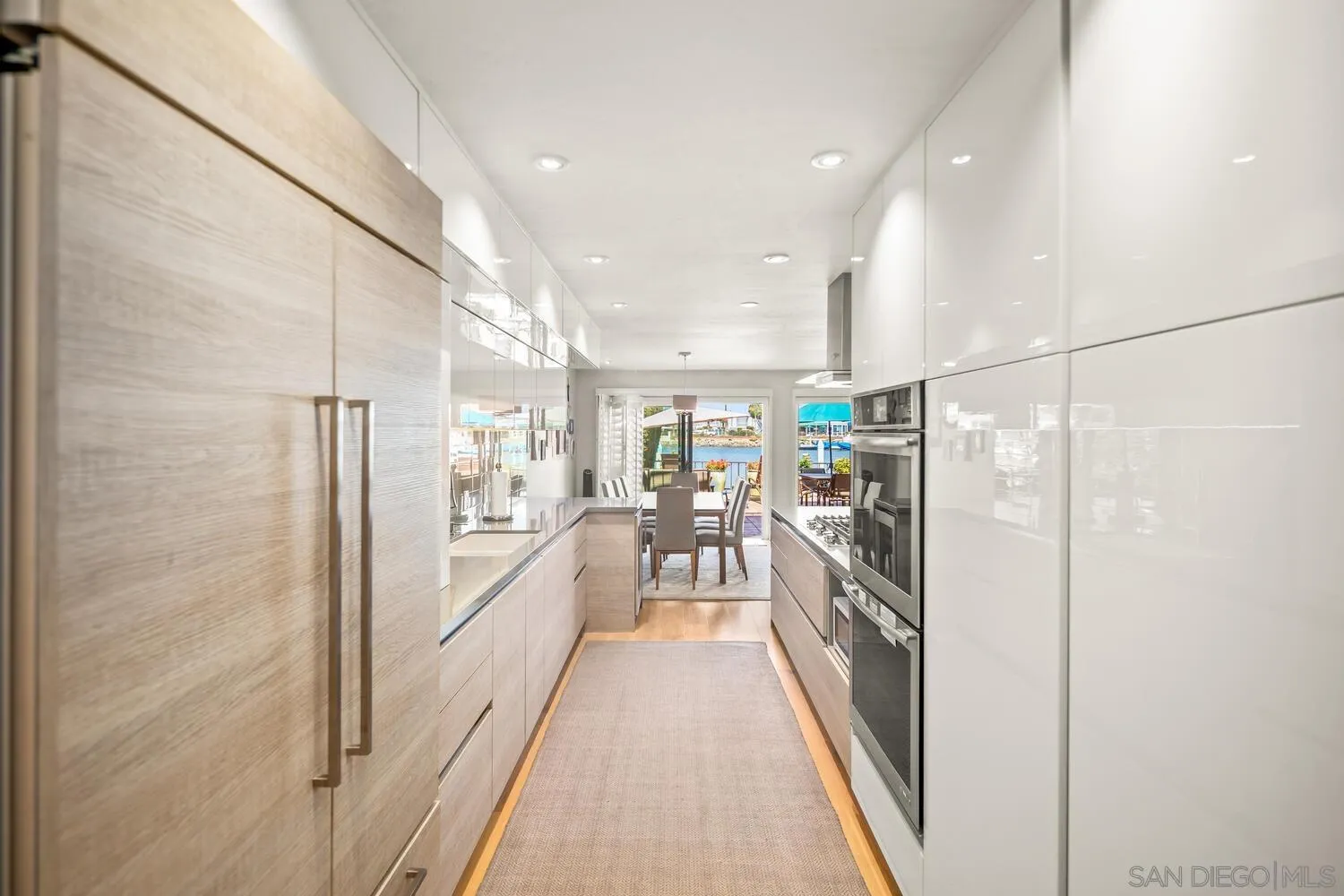 37 Antigua Court Coronado, CA 92118 - Photo 18 of 39 a view of a kitchen with fridge and wooden floor