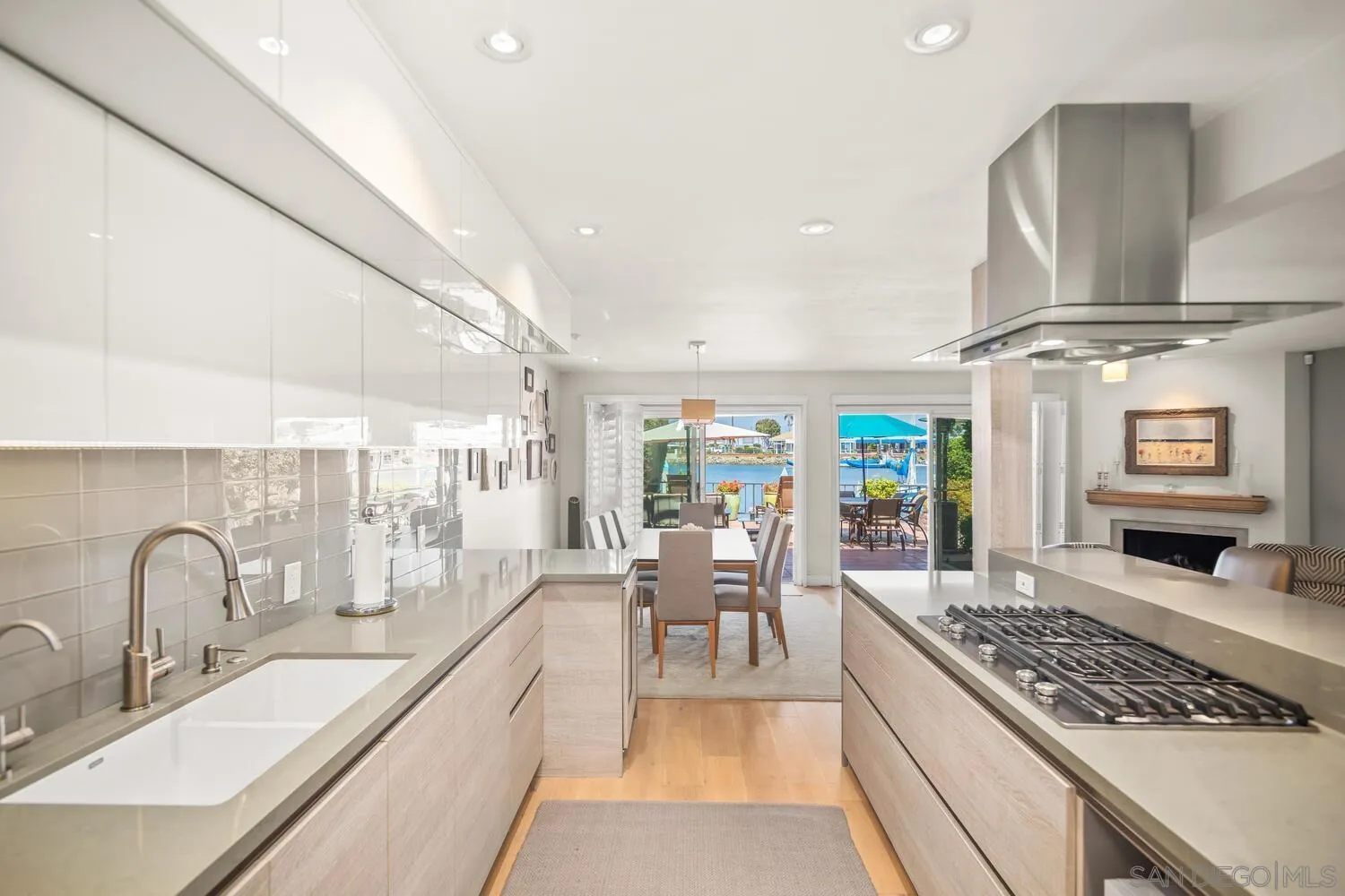 37 Antigua Court Coronado, CA 92118 - Photo 19 of 39 a large kitchen with stainless steel appliances granite countertop a lot of counter space and a dining table