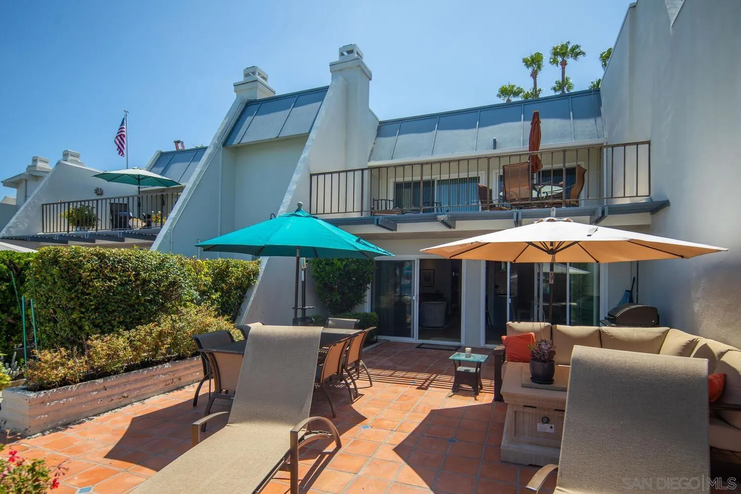 37 Antigua Court Coronado, CA 92118 - Photo 9 of 39 a patio with a table and chairs under an umbrella