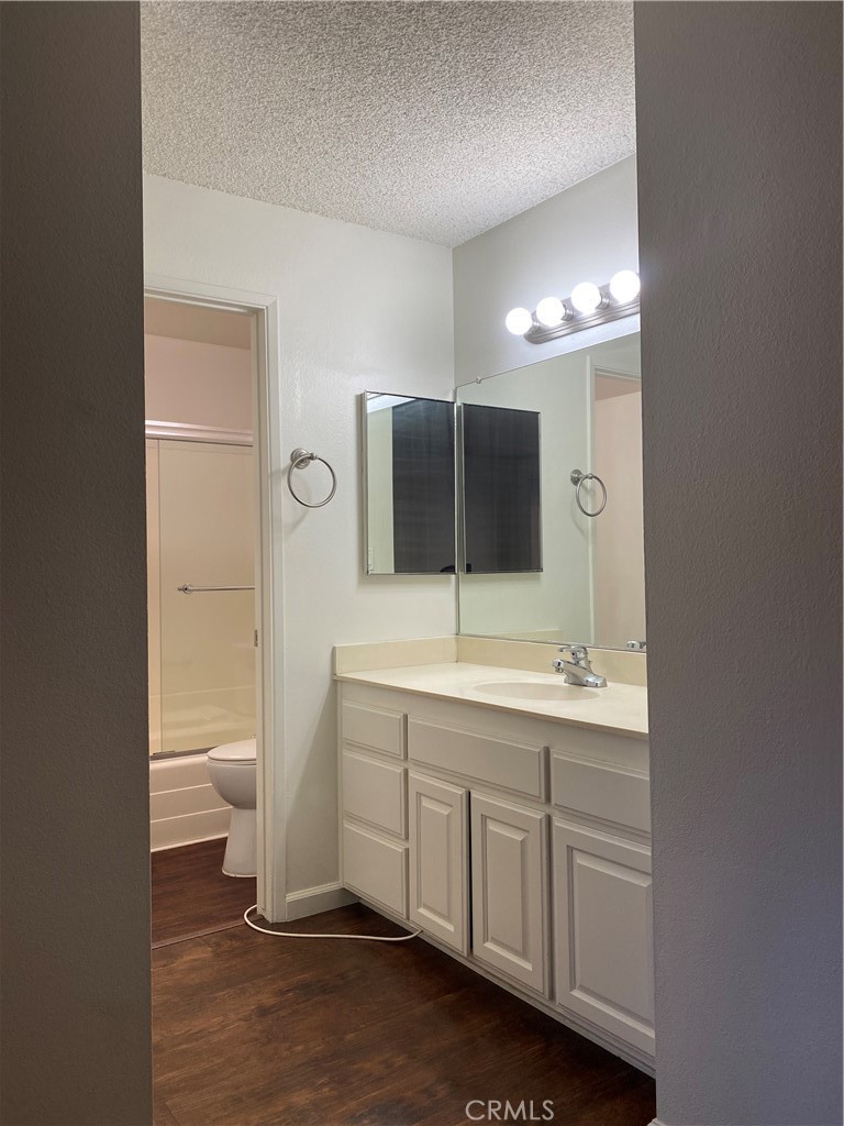 7890 East Spring Street, Unit 19A Long Beach, CA 90815 - Photo 12 of 24 a bathroom with a double vanity sink toilet and mirror