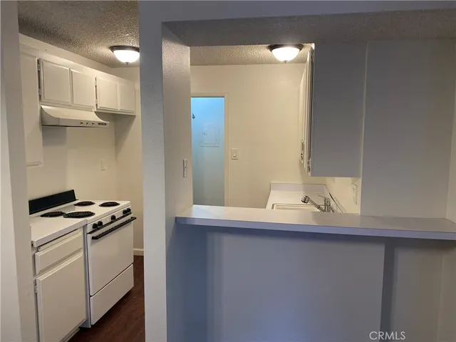 a kitchen with stainless steel appliances a sink stove and cabinets
