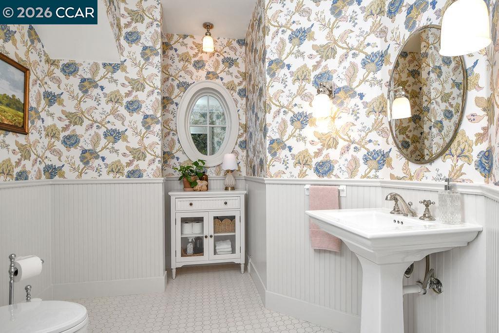 1751 Reliez Valley Road Lafayette, CA 94549 - Photo 16 of 60 a bathroom with a sink and mirror with toilet