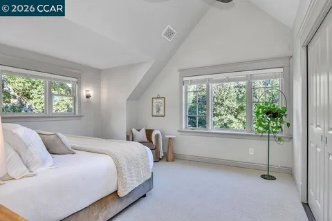 a spacious bedroom with a bed and a window