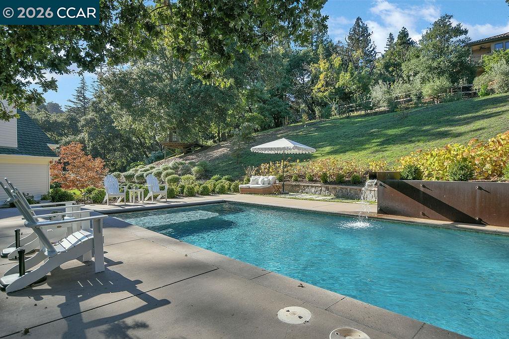 1751 Reliez Valley Road Lafayette, CA 94549 - Photo 26 of 60 a view of a swimming pool and lounge chairs in back yard of the house