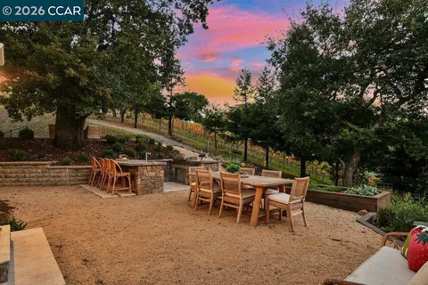 a view of a patio with table and chairs and potted plants