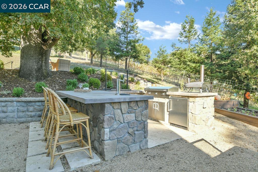 1751 Reliez Valley Road Lafayette, CA 94549 - Photo 31 of 60 a view of a patio with table and chairs and potted plants