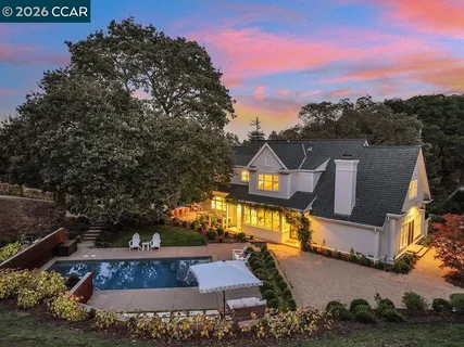 a living room with furniture a table and a large window