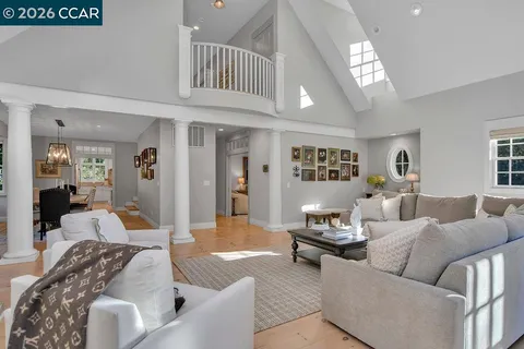a dining room with furniture a chandelier and wooden floor