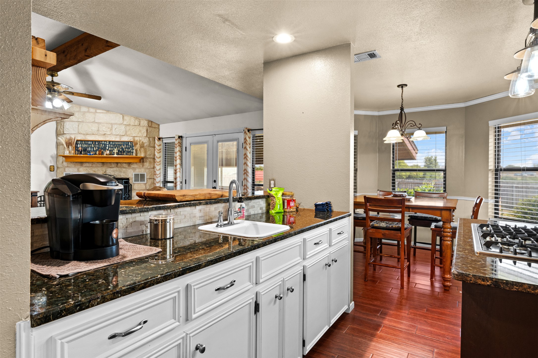1512 Panther Loop Pflugerville, TX 78660 - Photo 23 of 40 A well-appointed kitchen features rich hardwood flooring and a functional breakfast bar for casual dining.