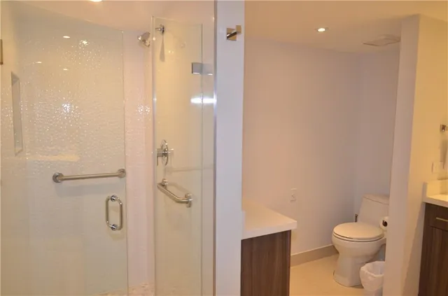 a bathroom with a shower a toilet and sink