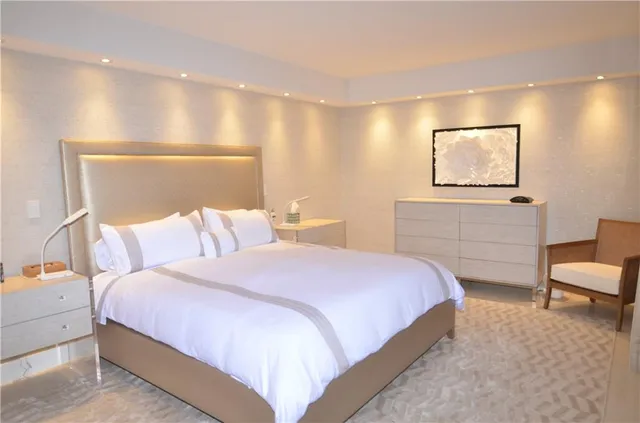 a bedroom with a bed and a painting on the wall