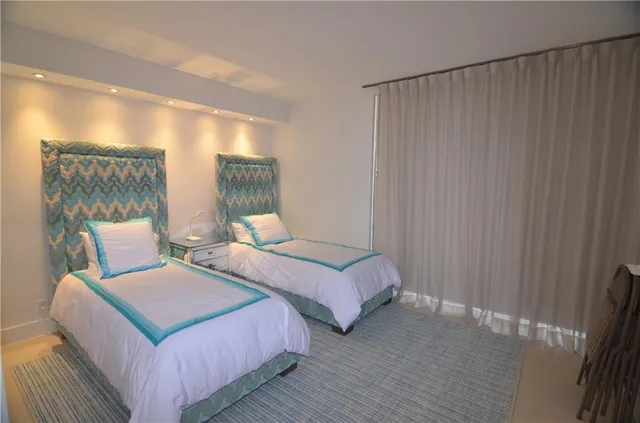 a bedroom with two beds and painted walls