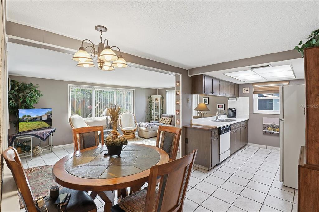 7410 Gulf Highlands Drive Port Richey, FL 34668 - Photo 13 of 45 a view of a dining room with furniture a livingroom and chandelier
