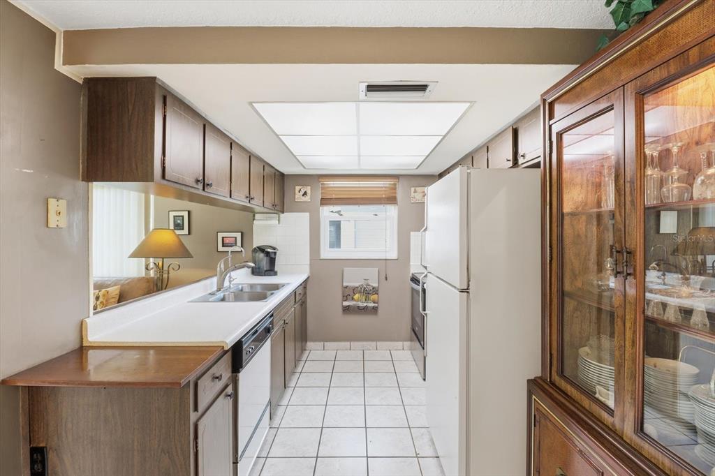 7410 Gulf Highlands Drive Port Richey, FL 34668 - Photo 15 of 45 a kitchen with a sink appliances and cabinets