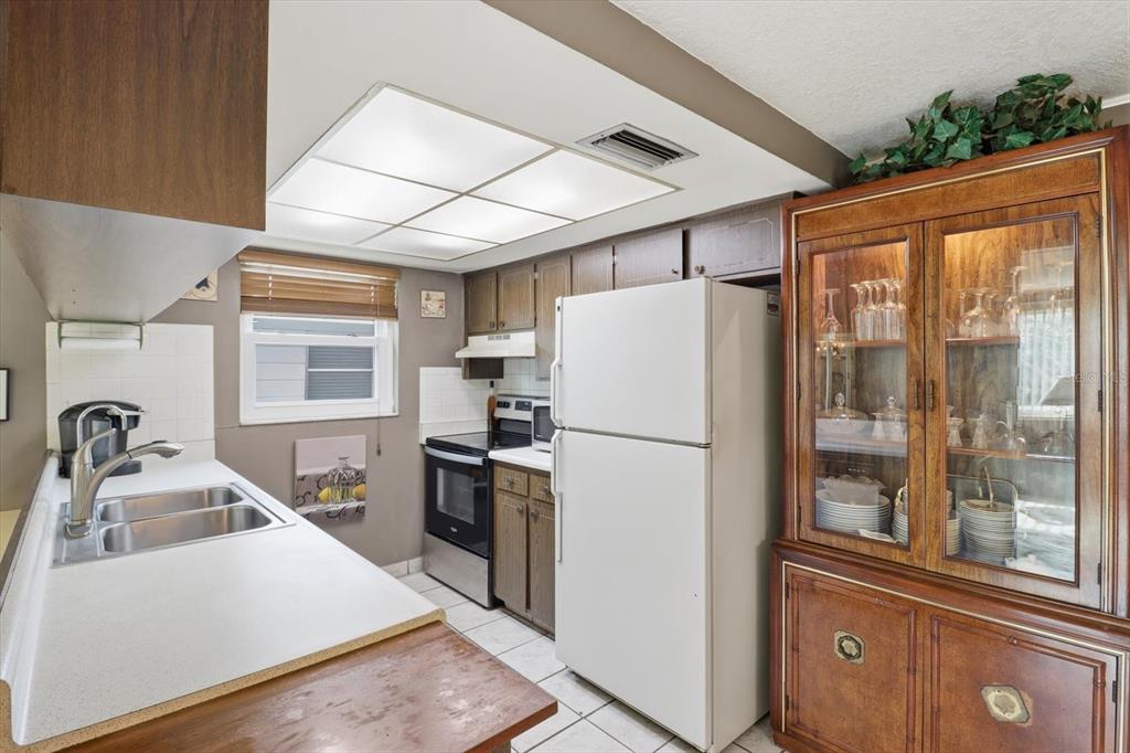 7410 Gulf Highlands Drive Port Richey, FL 34668 - Photo 16 of 45 a kitchen with a refrigerator a sink and a stove
