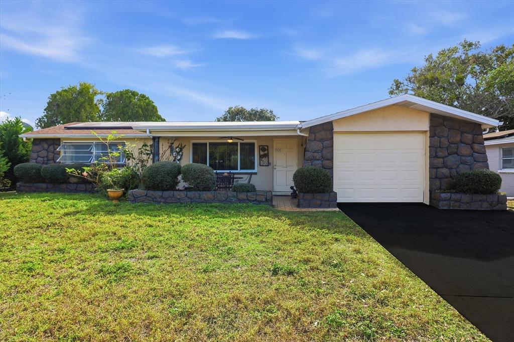 7410 Gulf Highlands Drive Port Richey, FL 34668 - Photo 2 of 45 a front view of house with yard and green space