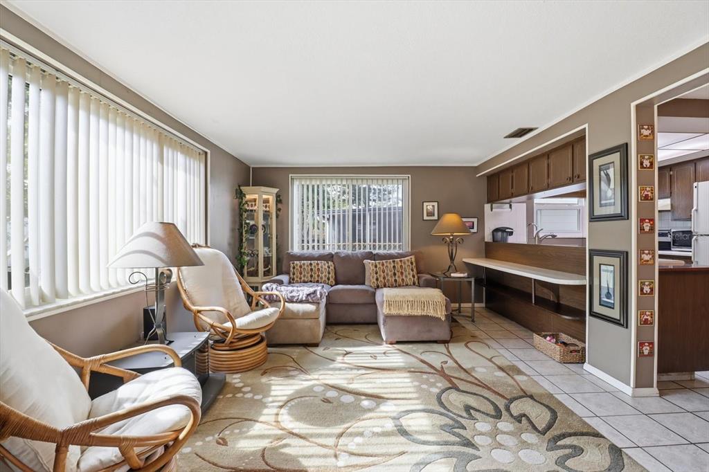 7410 Gulf Highlands Drive Port Richey, FL 34668 - Photo 21 of 45 a living room with furniture a rug and a window