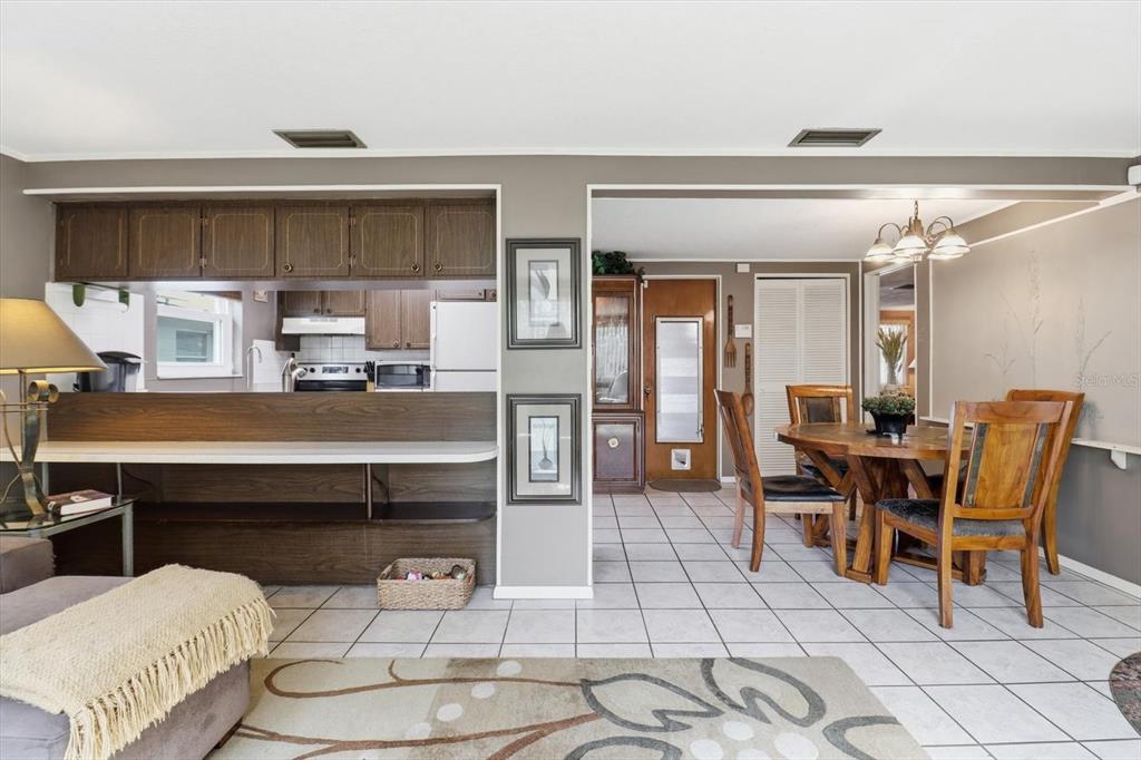 7410 Gulf Highlands Drive Port Richey, FL 34668 - Photo 23 of 45 a dining hall with stainless steel appliances kitchen island granite countertop a dining table and chairs