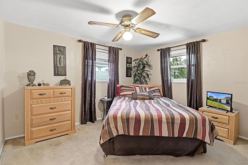 7410 Gulf Highlands Drive Port Richey, FL 34668 - Photo 25 of 45 a bedroom with a bed and a chandelier