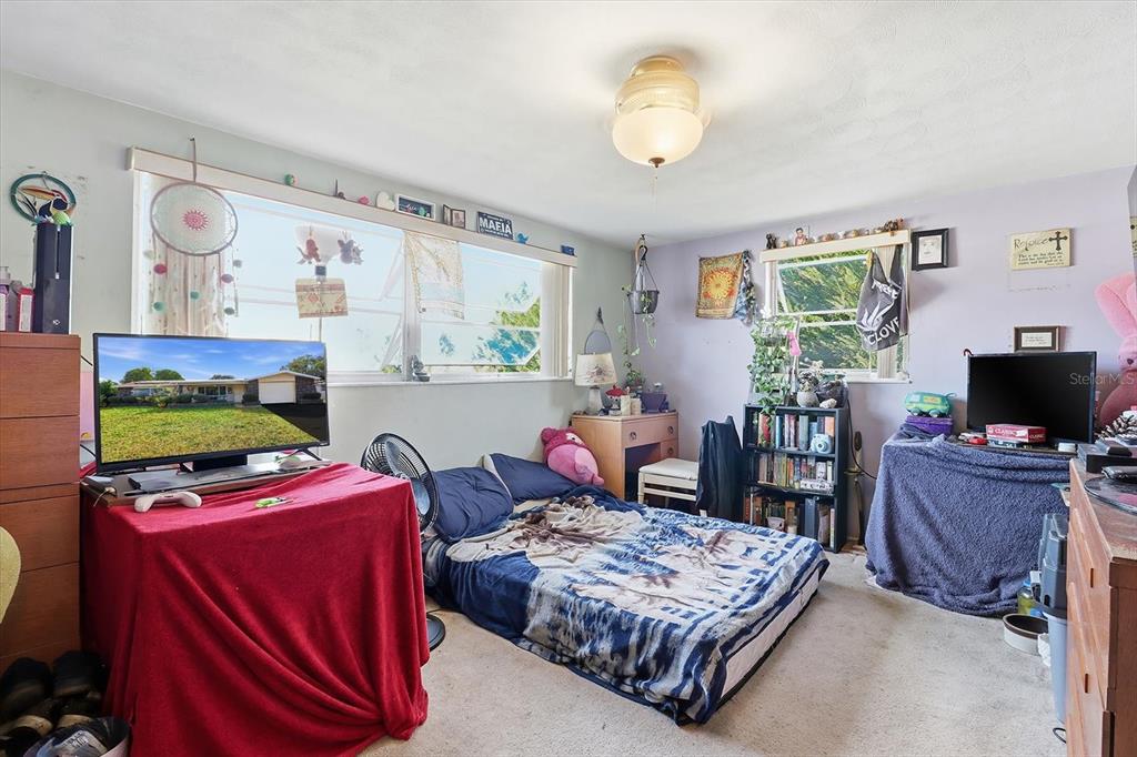 7410 Gulf Highlands Drive Port Richey, FL 34668 - Photo 29 of 45 a living room with furniture and a flat screen tv