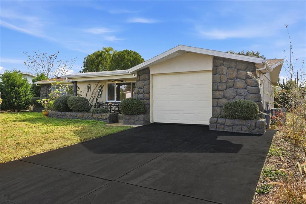 7410 Gulf Highlands Drive Port Richey, FL 34668 - Photo 3 of 45 a front view of a house with garden