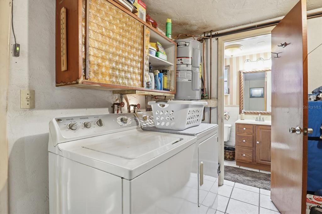 7410 Gulf Highlands Drive Port Richey, FL 34668 - Photo 31 of 45 a utility room with dryer and washer