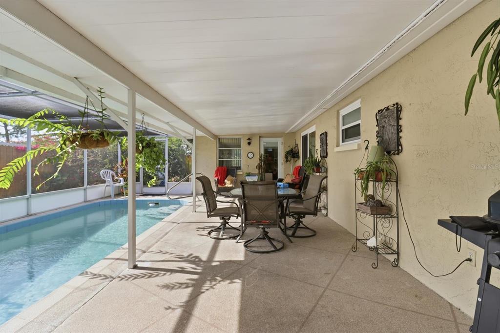 7410 Gulf Highlands Drive Port Richey, FL 34668 - Photo 37 of 45 a view of a patio with dining table and chairs