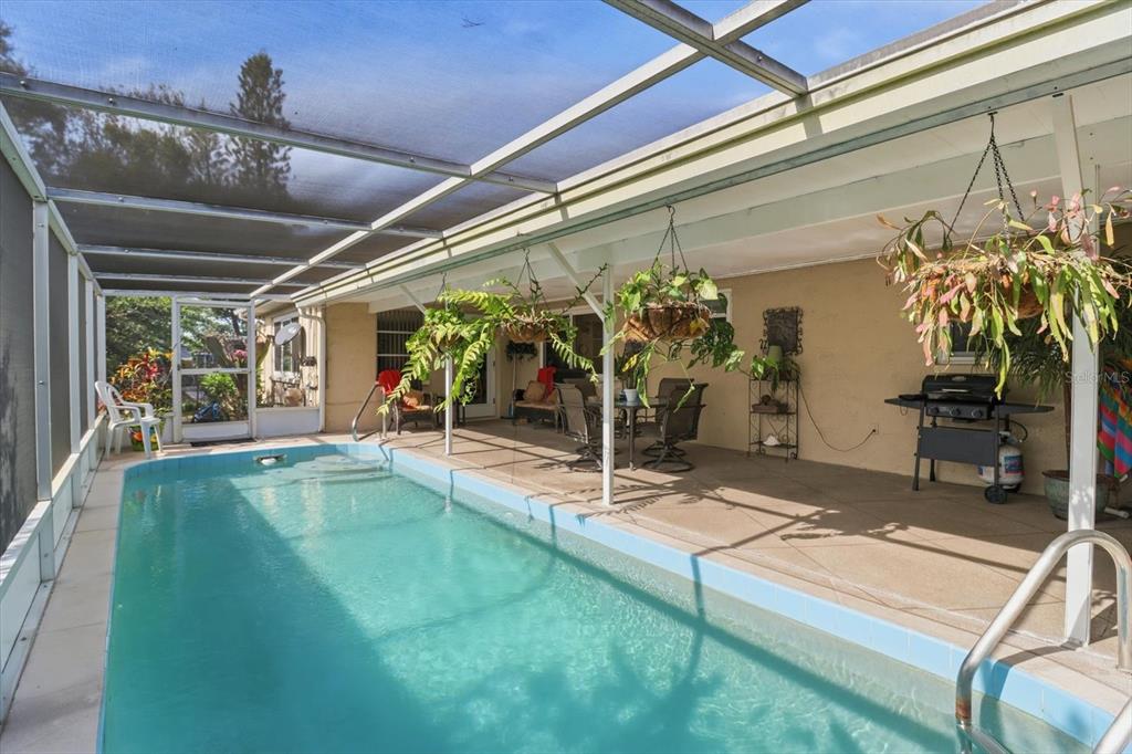 7410 Gulf Highlands Drive Port Richey, FL 34668 - Photo 39 of 45 a view of a porch with a table and chairs