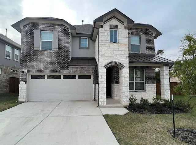 a front view of a house with garden