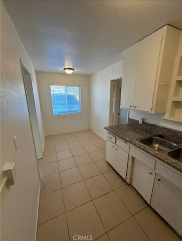 a kitchen with stainless steel appliances a sink stove and cabinets
