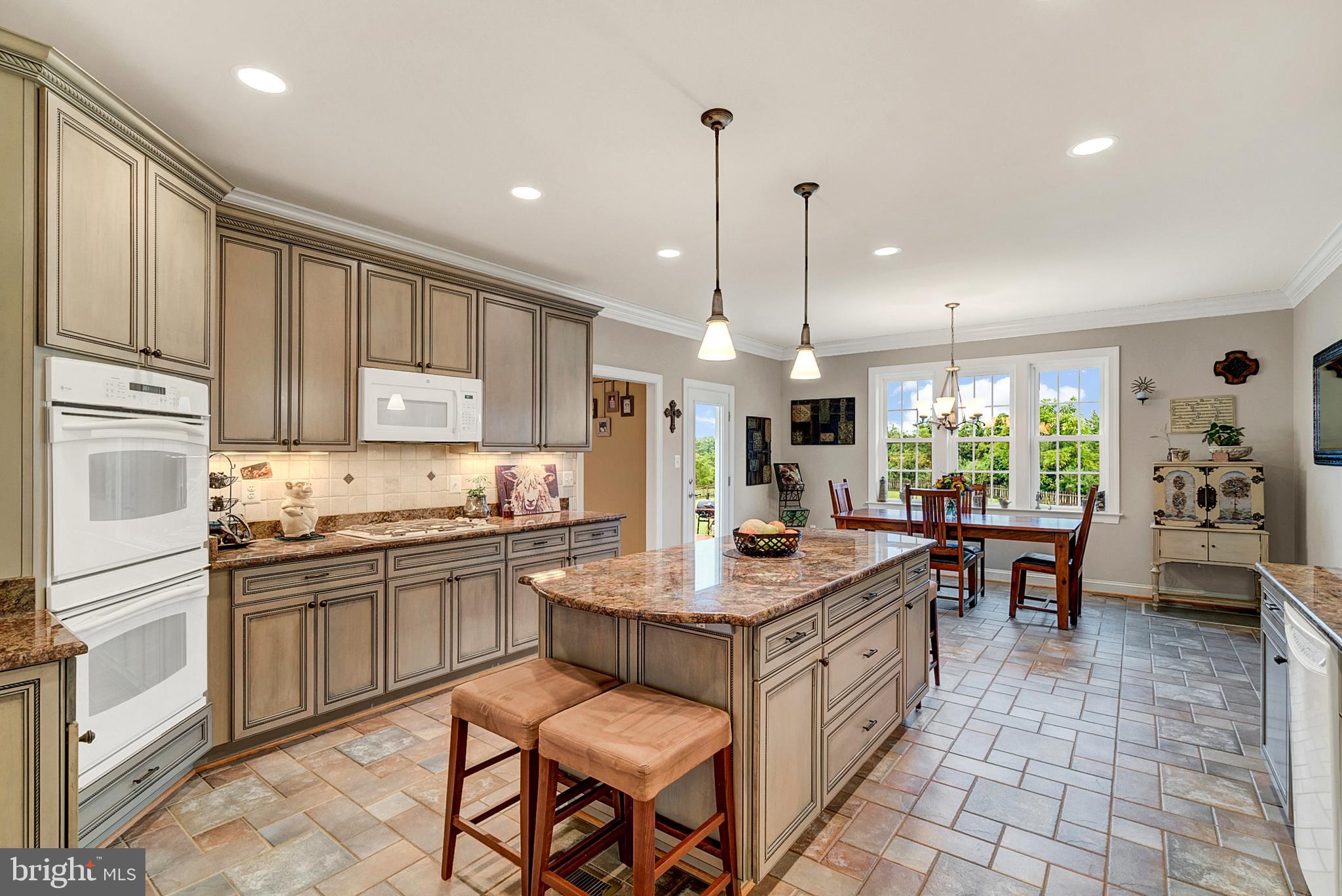 8633 Shepherds Way Rixeyville, VA 22737 - Photo 17 of 48 a kitchen with stainless steel appliances granite countertop a stove a sink a oven a dining table and chairs