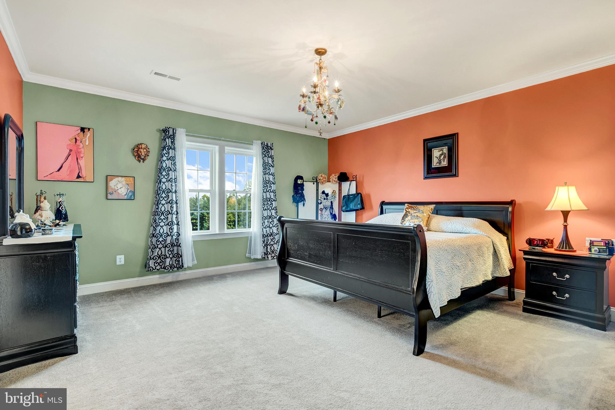 8633 Shepherds Way Rixeyville, VA 22737 - Photo 28 of 48 a bed room with a bed and a chandelier