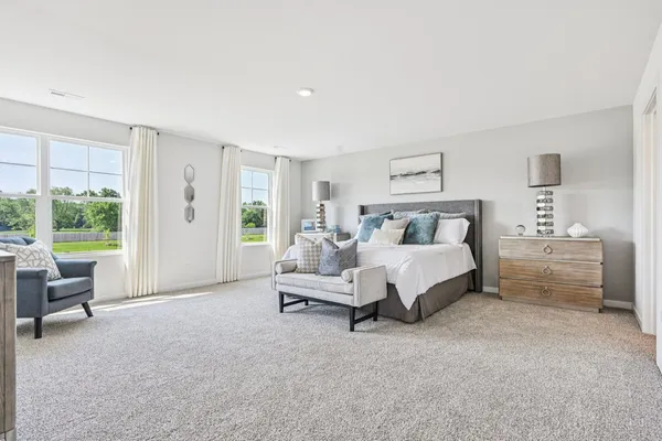 a spacious bedroom with a bed and a couch