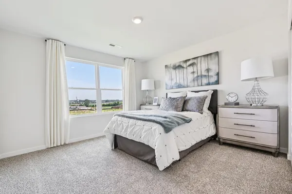 a bed room with a bed and a window