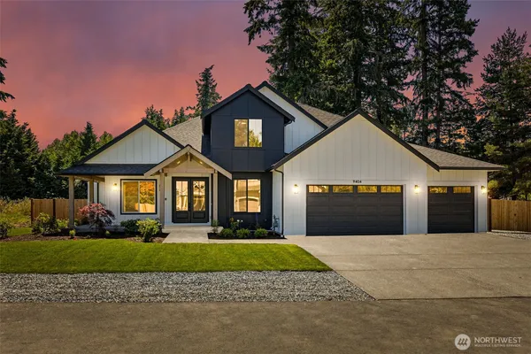 a front view of a house with a yard and garage