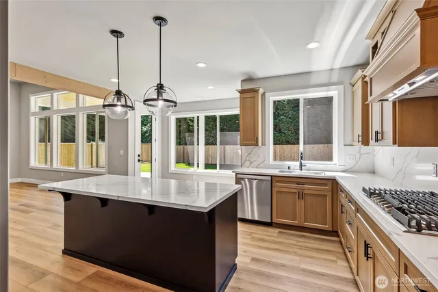 a kitchen with sink stove and window