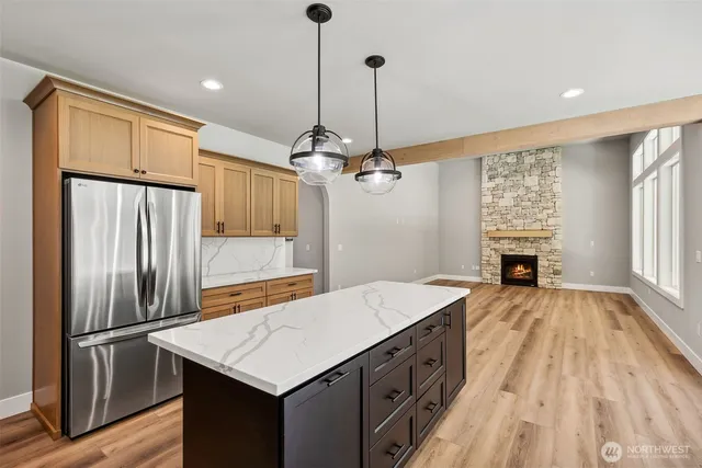 a kitchen with kitchen island white cabinets and stainless steel appliances