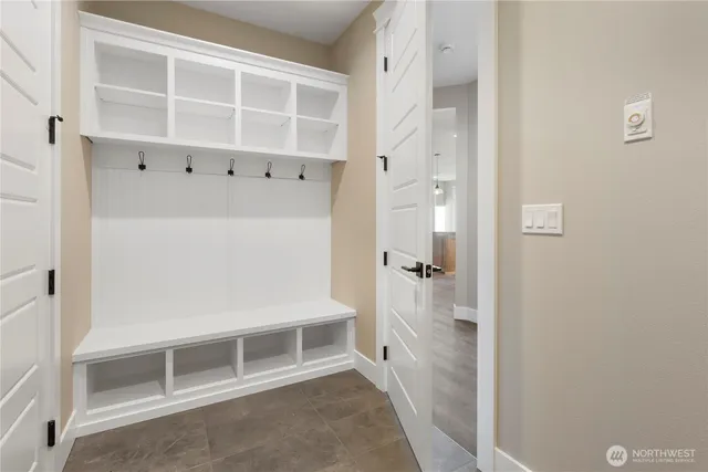 a view of an empty room with wooden floor and a cabinet