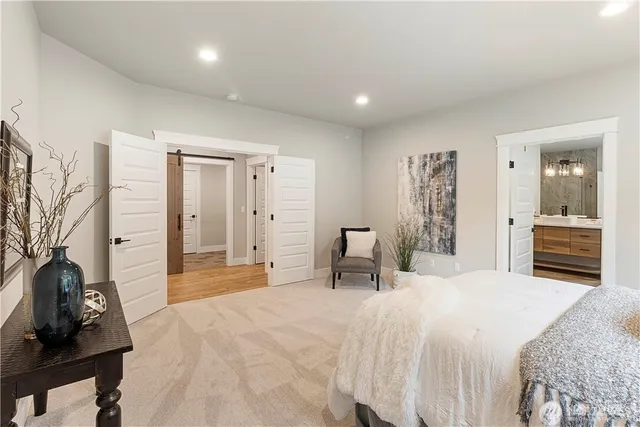 a bedroom with a bed and a chandelier