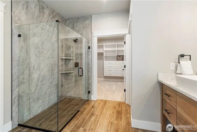 a bathroom with a shower and a sink