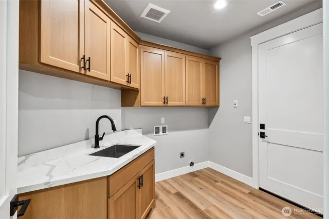 a kitchen with a sink cabinets and a window
